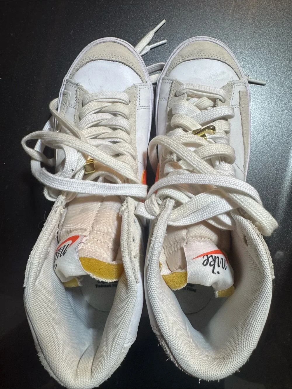 Nike White High-Top Sneakers with Orange Swoosh